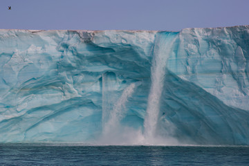 Glacial melt leads to waterfalls on the third largest ice cap in the world. © Katharine Moore