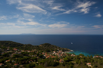 Fototapeta na wymiar The town of Sant'Andrea overlooks the sea of the island of Elba, in the background the island of montecristo. Italy