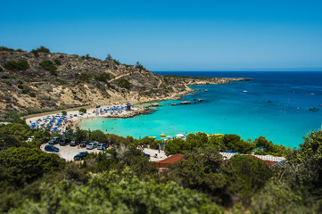 Naklejka na ściany i meble Beautiful beach in the blue lagoon on the sea. Seascape. Beautiful coast of Cyprus. Resort area in Cyprus. The Beaches Of Cyprus. Greek beaches. Paid beaches