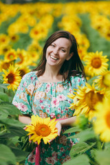 Brunette girl in a field of sunflowers