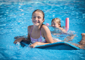 little girl is swimming in the pool on the blackboard