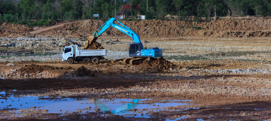 Backhoe're dredging the pond to store water for use during the dry season.