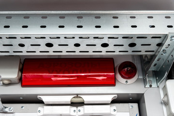 Metal cable tray and alarm system lamp over the door