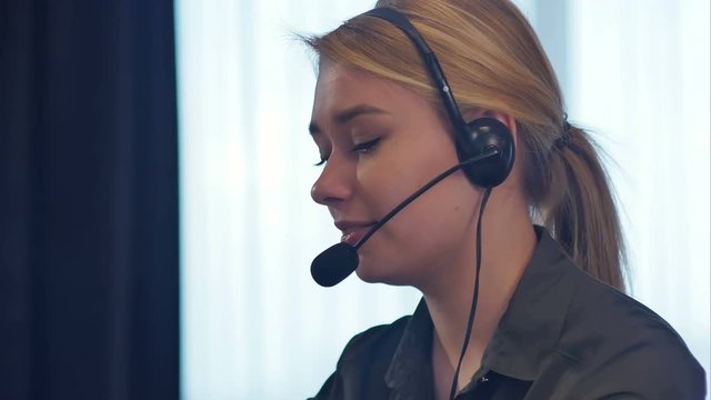 Female customer support operator with headset talking and smiling