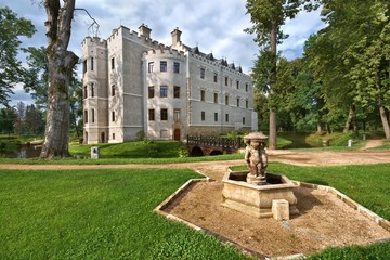 Fountain in a garden surrounding neo-Gothic style castle in Karpniki, Poland