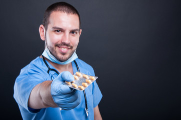 Selective focus of doctor wearing scrubs handing tablets