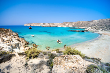 Fototapeta premium Amazing view of Koufonisi island with magical turquoise waters, lagoons, tropical beaches of pure white sand and ancient ruins on Crete, Greece