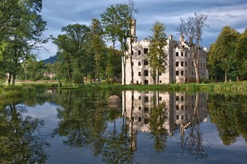 Fototapeta na wymiar Neo-Gothic style castle surrounded by an English landscape garden in Karpniki, Poland