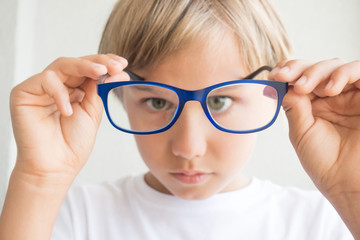 Boy holding glasses and looking through it