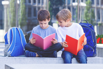 Children doing homework outdoors.