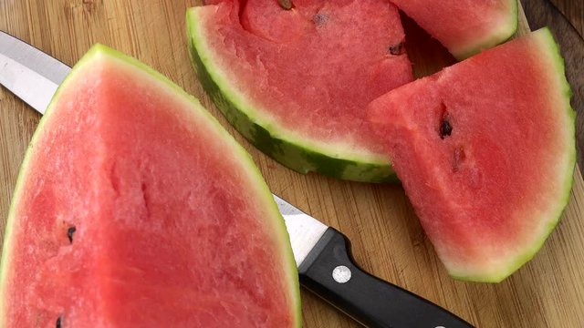 Water Melon on a rotating wooden plate (seamless loopable; 4K)