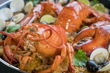 Paella with fresh lobster, clams, mussels and squid