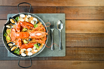 Paella with fresh lobster, clams, mussels and lime
