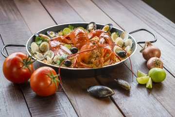 Paella with fresh lobster, clams, mussels and squid