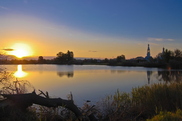 Fototapeta na wymiar Dawn over the lake with the church