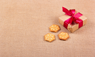 Christmas cookies in the form of snowflakes and a gift box. Festive concept. New Year's and Christmas. Copy space