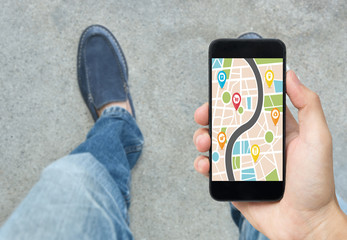 hand holding smart phone with map gps navigation application. concept guideline street travel