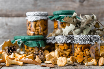 Food in jar, marinated mushrooms on rustic wooden table, home made preserves in cellar