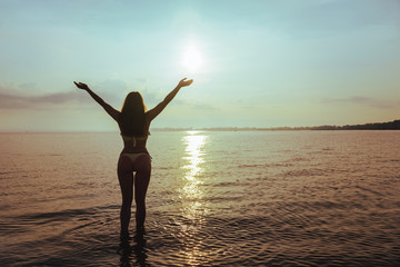 Fototapeta premium woman standing on the beach in sweemuit with sexy ass