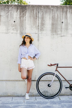 Woman standing at bike
