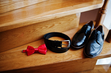 Groom's black wedding shoes, belt and other accessories.