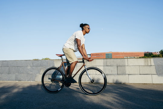 Black man riding bicycle