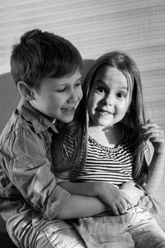 Black and white photo of a boy and girl hugging