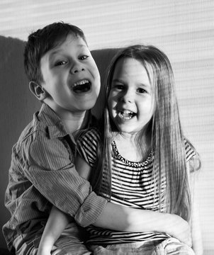 Black and white photo of a boy and girl hugging
