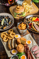 Grilled meat and vegetables on rustic wooden table