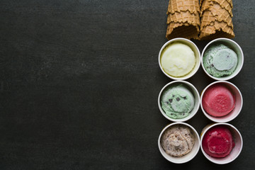 Top view of Ice cream flavors in cup and topping, sweet and dessert food concept