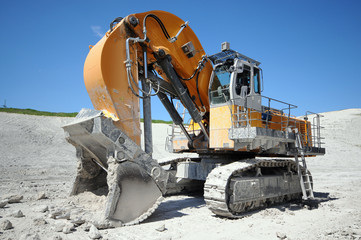 Fototapeta premium Excavator in a chalk rock quarry. mining industry.