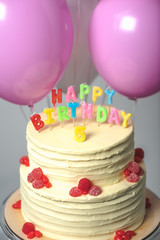 close-up view of delicious birthday cake with number five on top