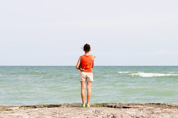 Girl and dog on the pier, looking into the distance