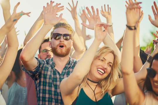 Group of people dancing and having good time at music festival