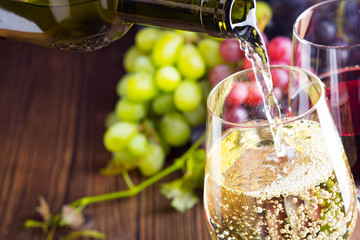 Pouring white wine into a wine glass