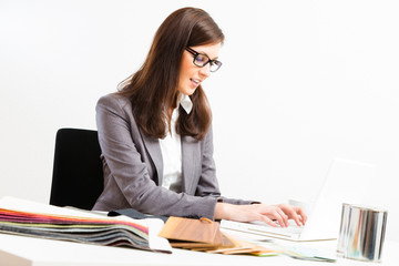 Female Interior Designer At Her Desk