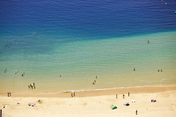 long ocean beach with people