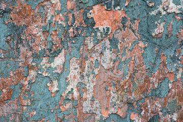 Fototapeta premium Grungy decaying cracked and peeling paint plaster wall texture background