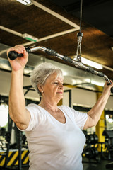 Active senior woman working exercise in the gym.