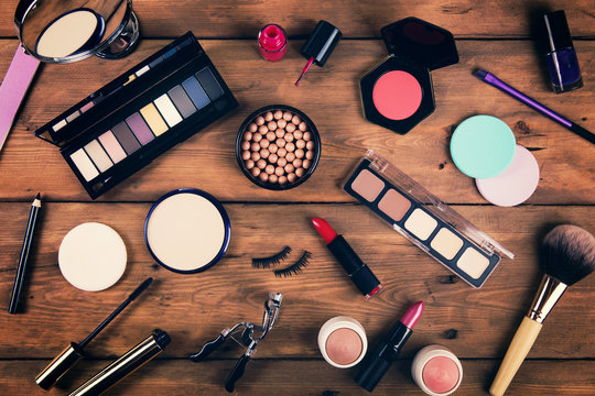makeup cosmetics on wooden background. top view