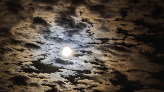 time lapse video of the moon coming through the clouds