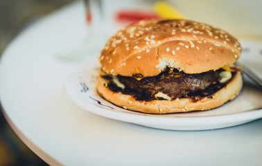 Home made burgers on a plate on caffe table.