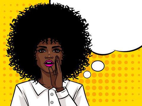 Young attractive Afro american girl wants to tell a secret. Portrait of a woman with dark skin and curly hair. Girl holding a hand near mouth.