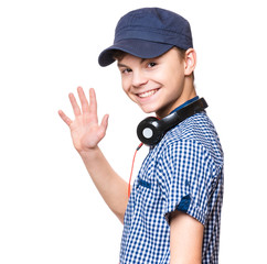 Portrait of young student with cap and headphones, isolated on white background. Confident teen boy...
