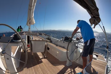 Papier Peint photo Lavable Naviguer Skipper driving sailboat / Captain of the yacht