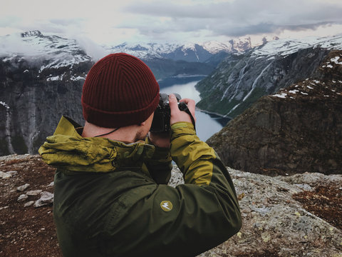 Man takes a picture of gorgeous Scandinavian landscape