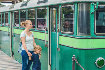 Mom and son are going to go on an old tram. Traveling with children in Hong Kong concept