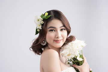 Beautiful asian woman bride on grey background. Closeup portraits with a professional makeup