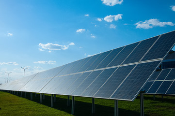 Solar panels, blue sky with fluffy clouds