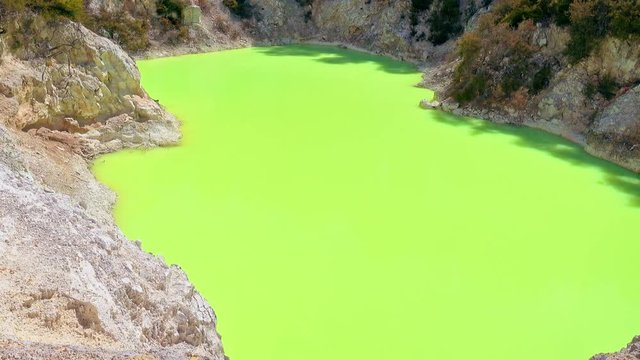 Amazing green colour of geothermal lake Devil's Bath. Wai-O-Tapu Geothermal Wonderland, Rotorua, New Zealand.